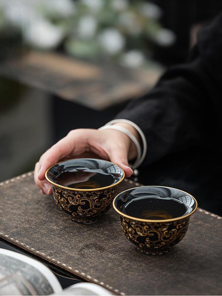 Imperial Black Porcelain Teacup with Gold Dragon Motif