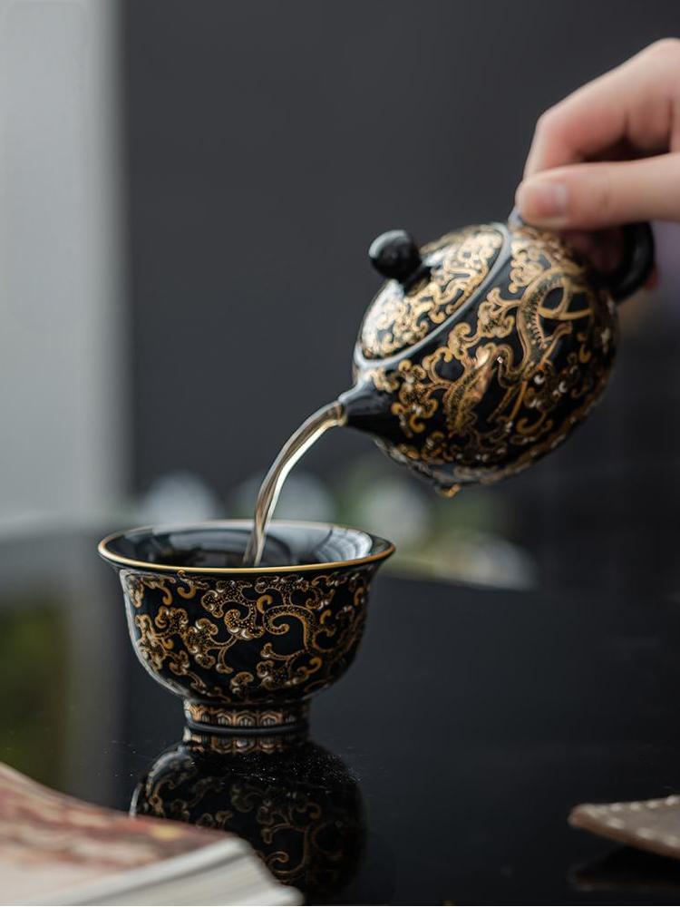Imperial Black Porcelain Teacup with Gold Dragon Motif